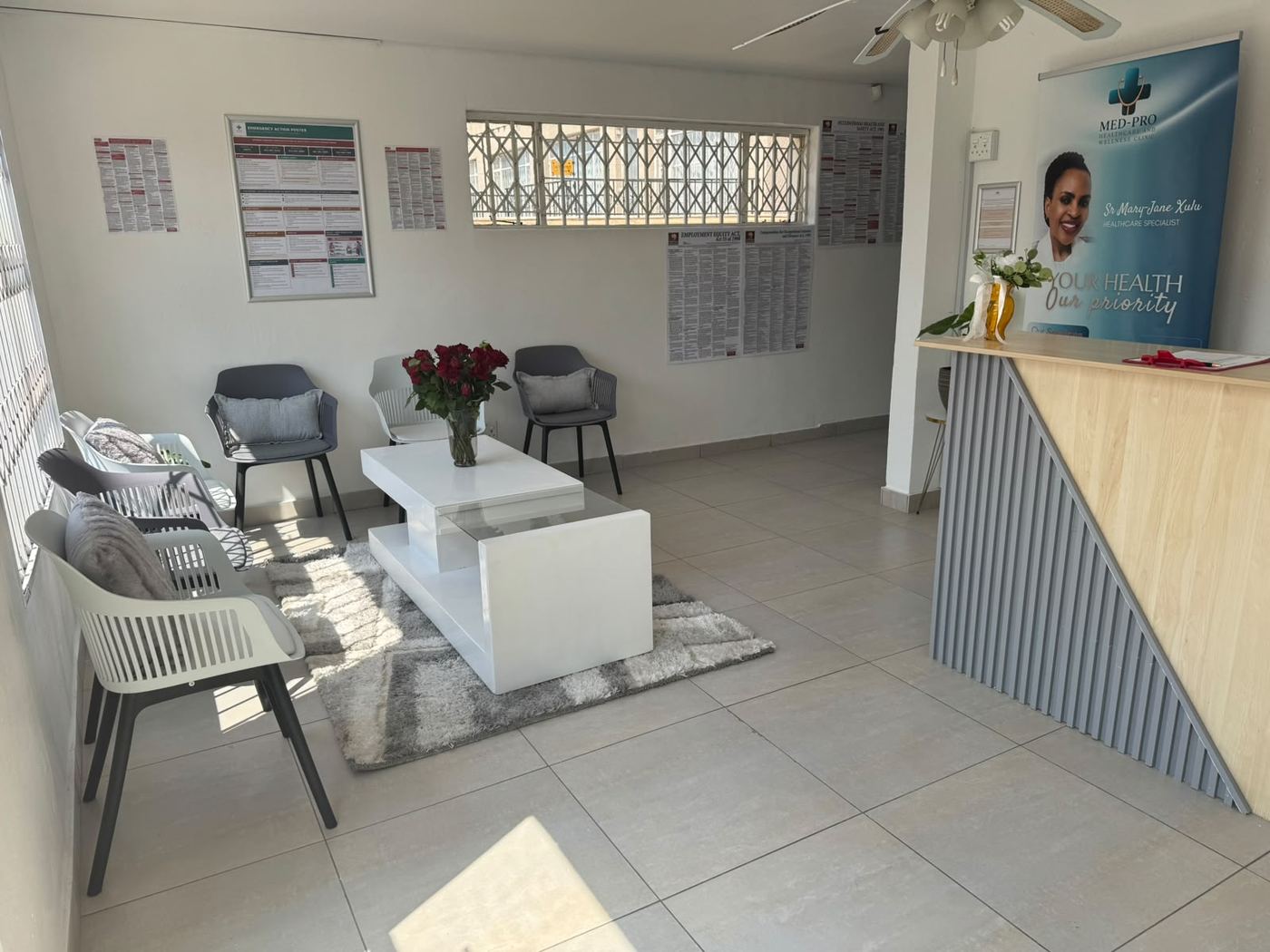 Med-Pro waiting area with seating, a rug and fresh flowers